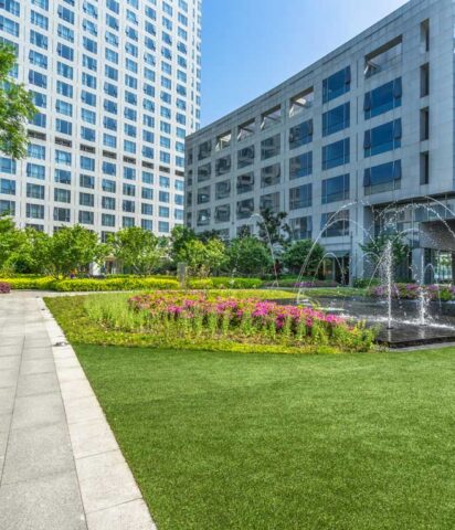 Freshly cut grass and manicured landscaping at an office building.