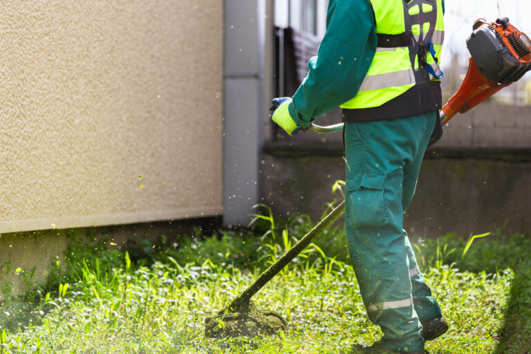 Commercial lawn maintenance worker finishing a job with high quality egger.