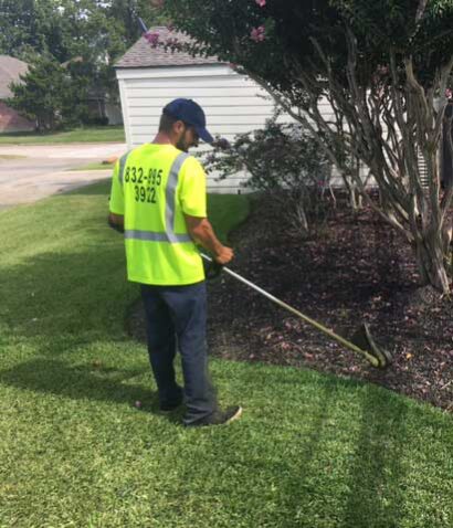 HMTC commercial landscaper working on a property in Houston, TX.