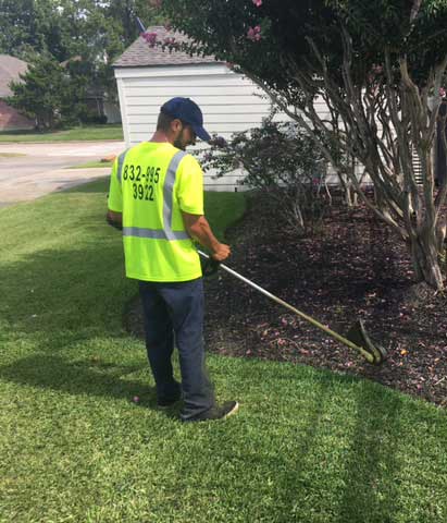 HMTC commercial landscaper working on a property in Houston, TX.