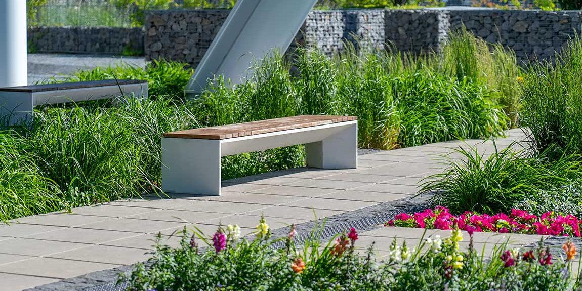 Professional-Landscaping-Sitting-Bench Professional landscaping with a sitting bench at an office building.